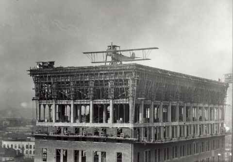 Frank Clarke flying plane off roof of Los Angeles Railway Building - 1920